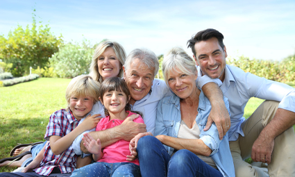 Three generations of smiling family outdoors