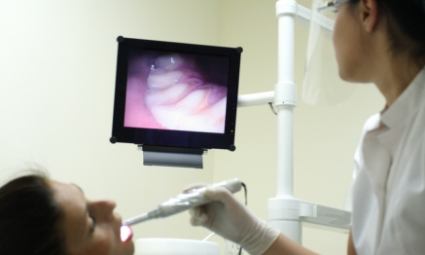 Dentist using intraoral camera to capture smile images