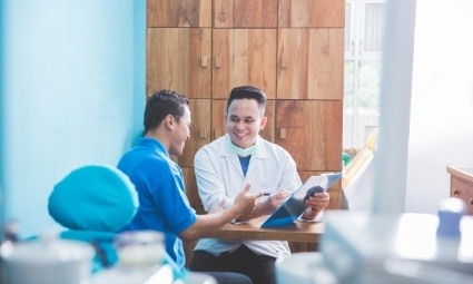 Dentist and dental patient reviewing dental insurance coverage