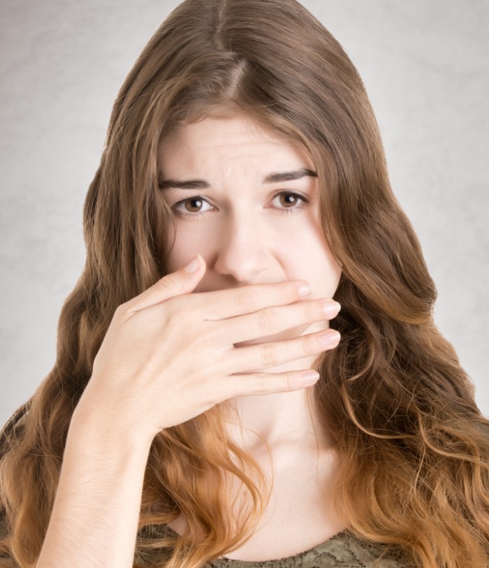 Woman covering her mouth