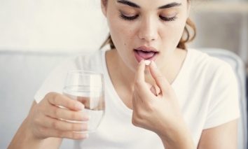 Woman taking pill