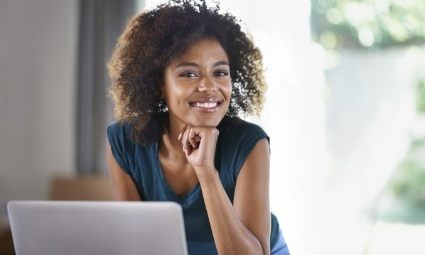 Smiling woman using a laptop