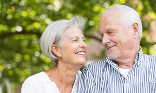 older couple smiling at each other 