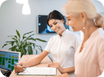 Dental team member reviewing financing options with dentistry patient