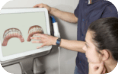 Dental patient looking at 3 D teeth model