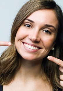 Woman pointing to her teeth