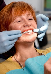 older woman smiling while visiting dentist